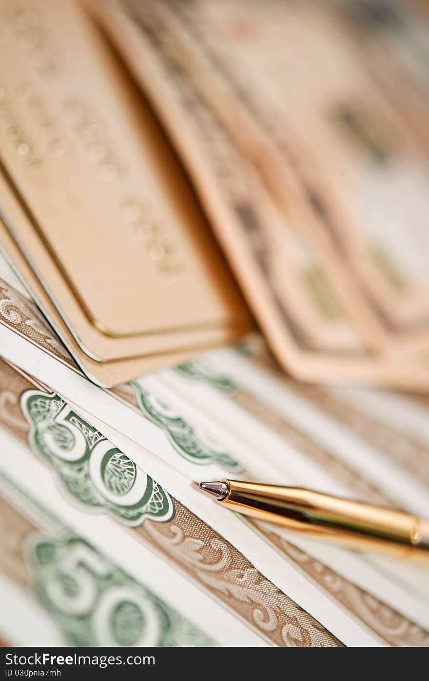 Golden pen, money and bank card. closeup. shallow depth of field. Golden pen, money and bank card. closeup. shallow depth of field.