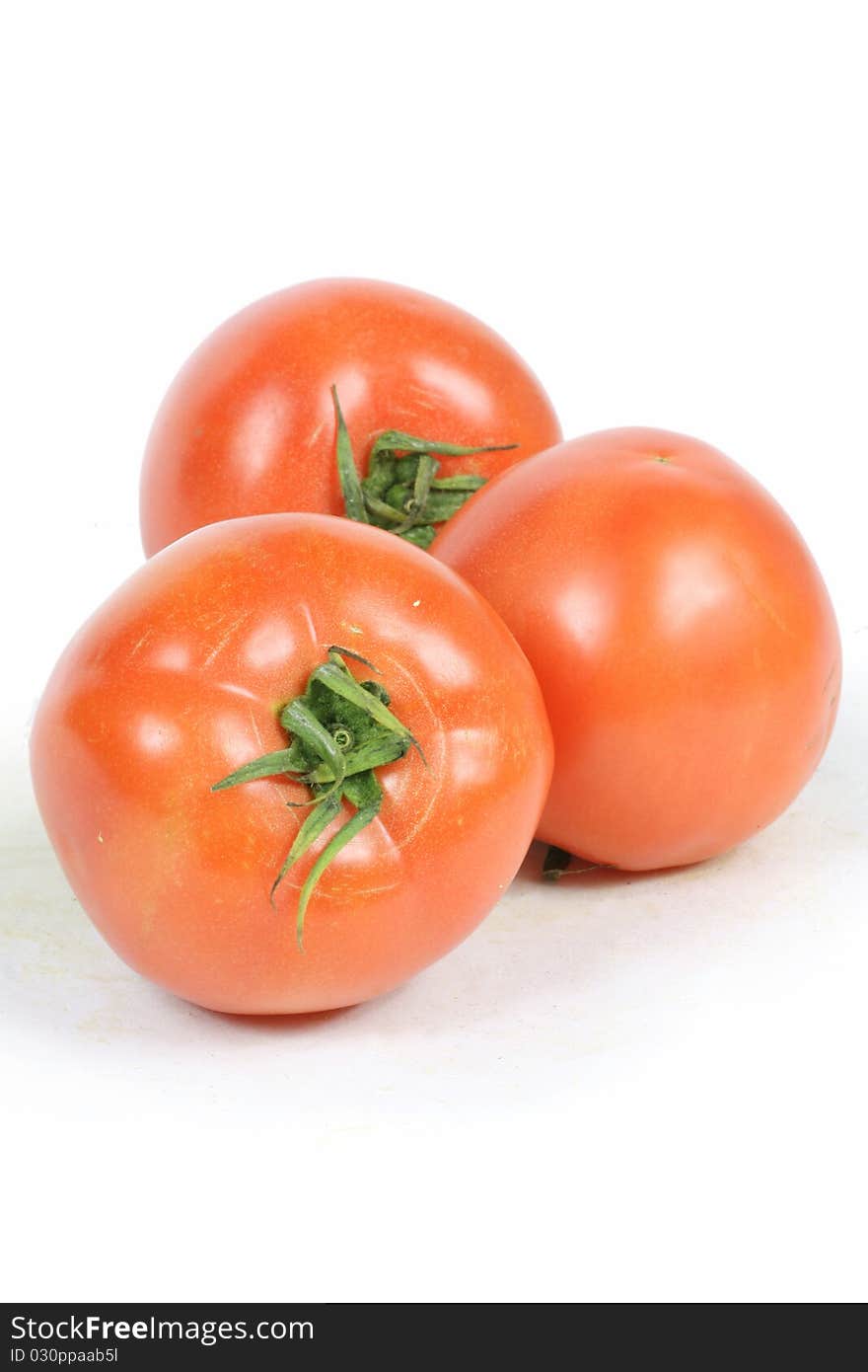 Three Red Tomato on white background