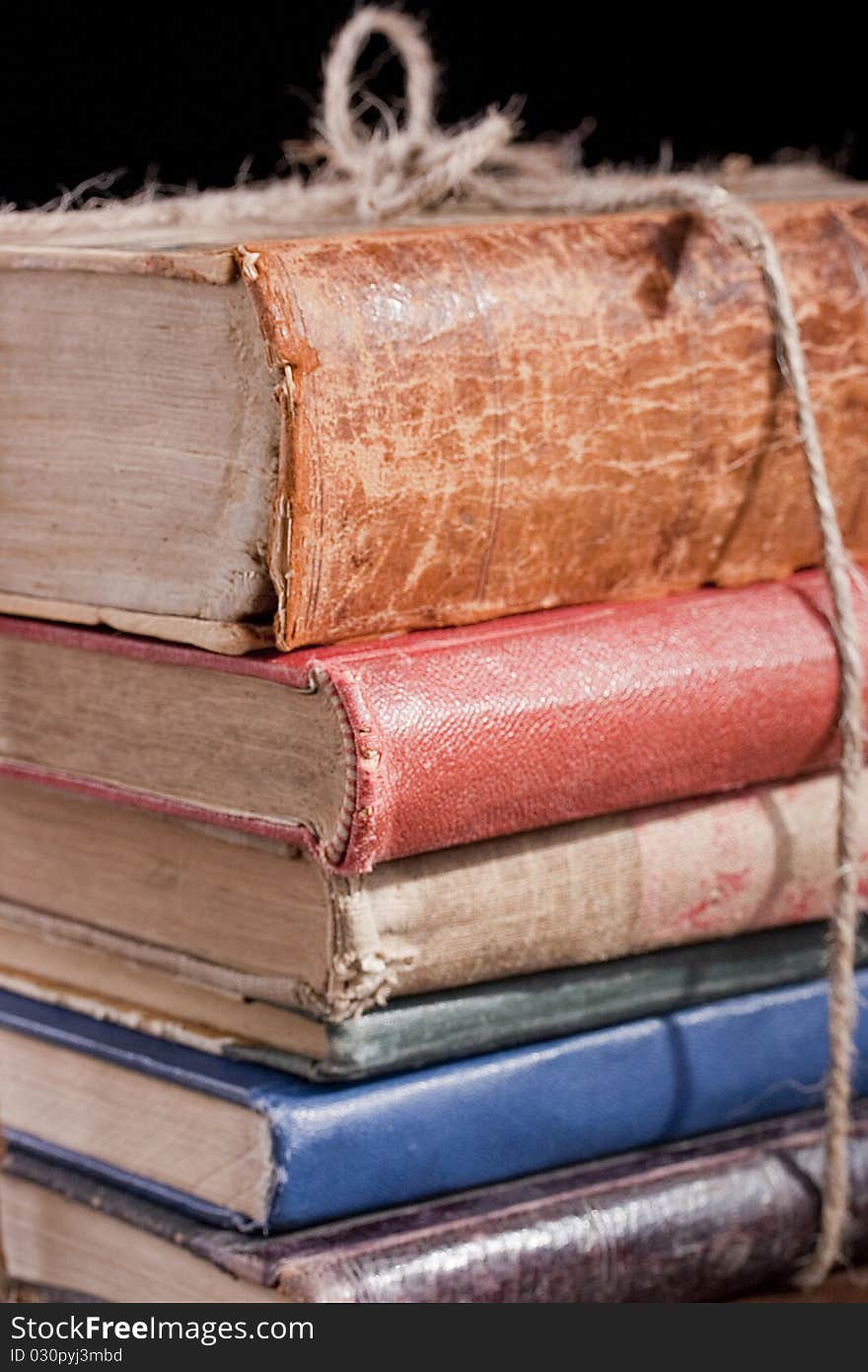 Archival documents in a book-depository are tied up by a cord.