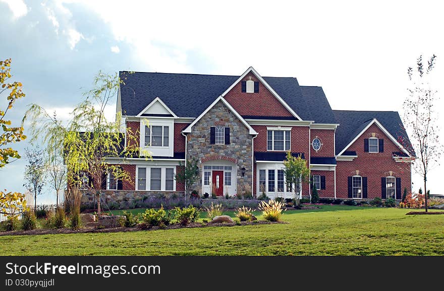 Stone faced mansion with elaborate landscaping. Stone faced mansion with elaborate landscaping.