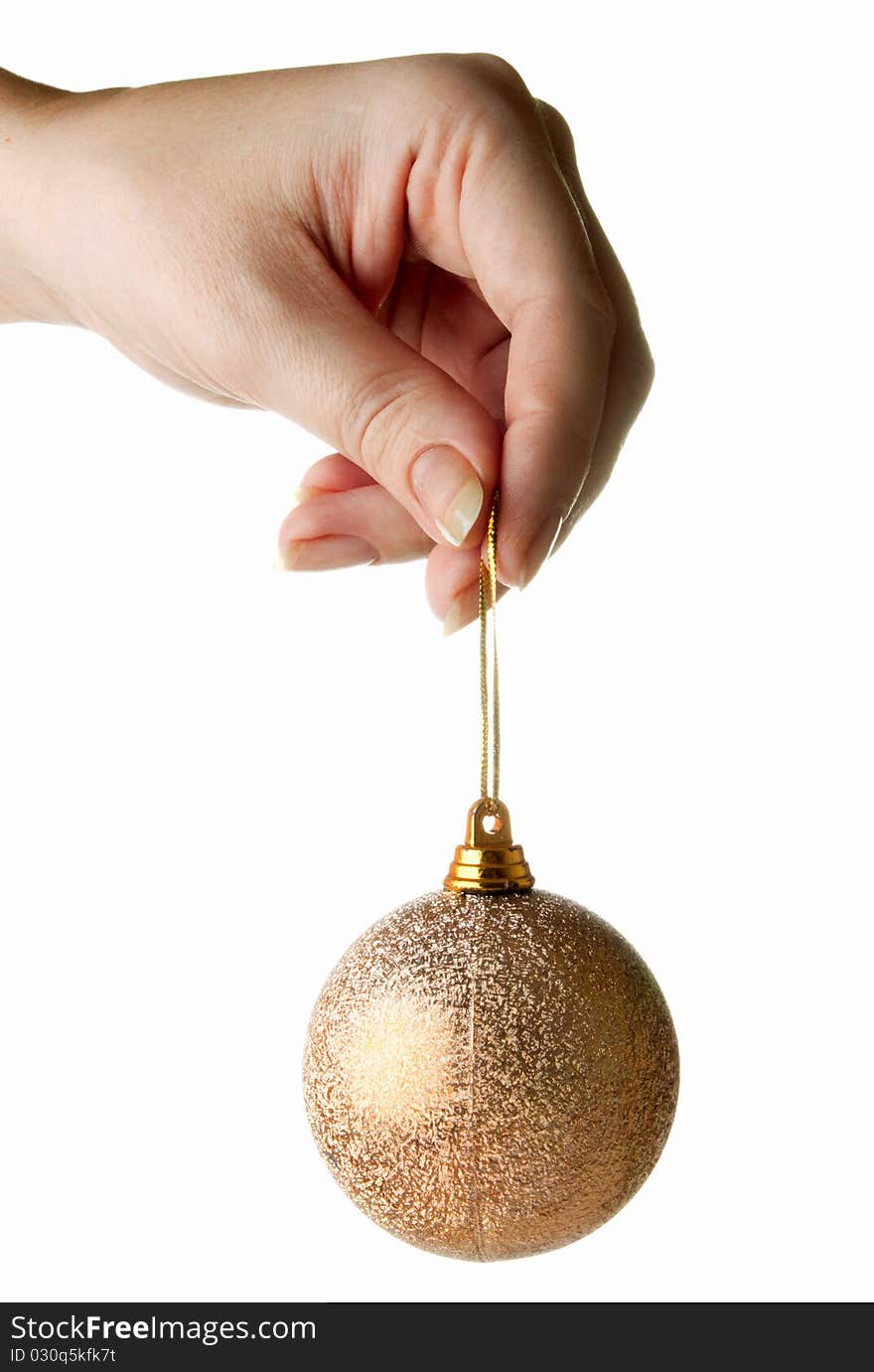 Female hand holding gold cristmas bauble isolated on white. Female hand holding gold cristmas bauble isolated on white