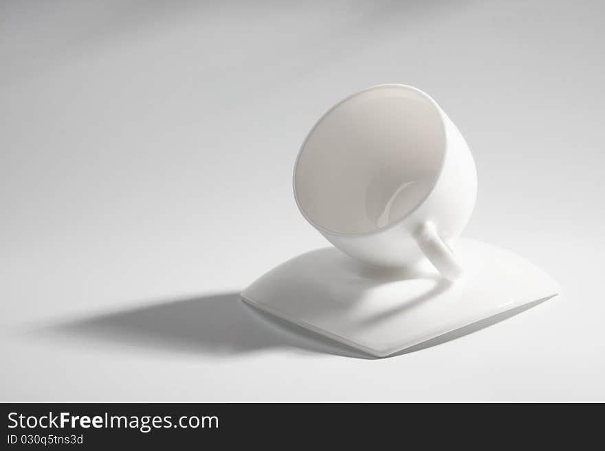 An empty coffee cup on a gray background with shadow