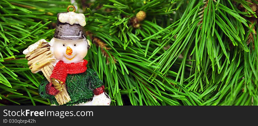 Cute snowman with sitting under a pine tree. Cute snowman with sitting under a pine tree