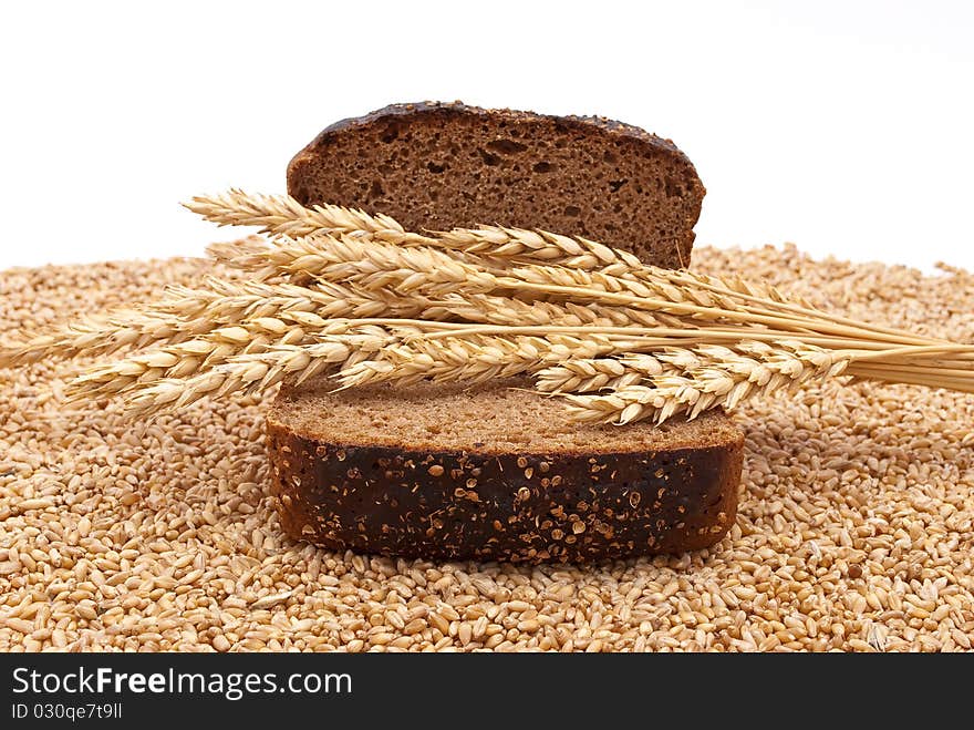 Slice bread with wheat ears on white