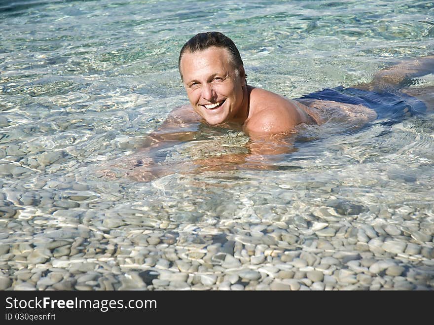 Color portrait of a A happy smiling man relaxing in the sea. Color portrait of a A happy smiling man relaxing in the sea