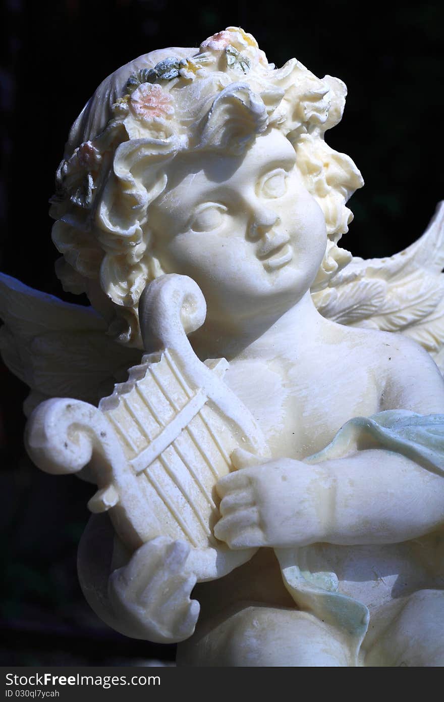 Statue of classic angel playing harp in morning light. Statue of classic angel playing harp in morning light