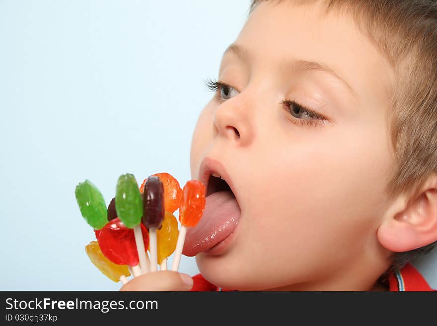 Beautiful blond boy with hand full of lollies. Beautiful blond boy with hand full of lollies