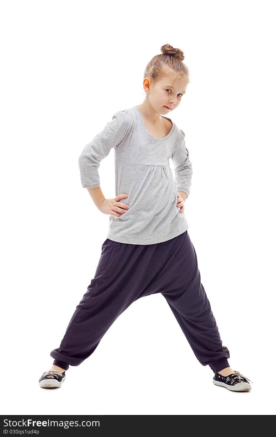 Sporty little girl posing on a white background