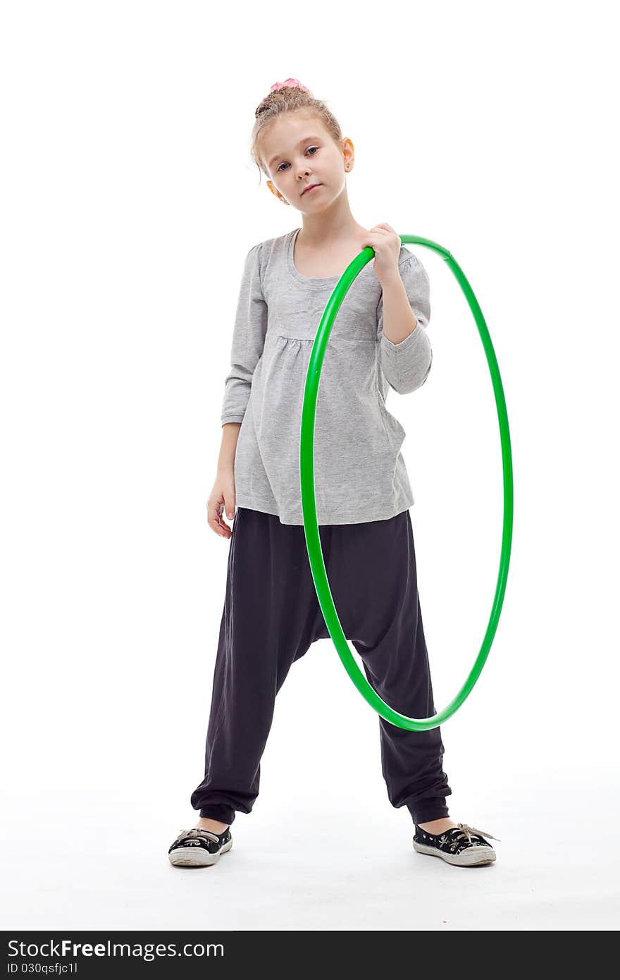 Sporty little girl with hula hoop posing on a white background. Sporty little girl with hula hoop posing on a white background