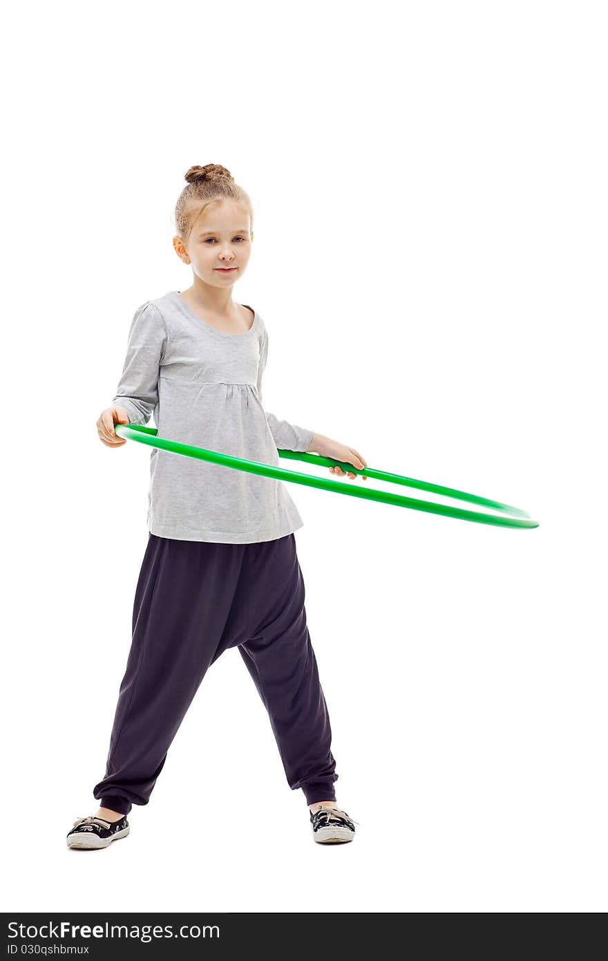 Sporty little girl with hula hoop posing on a white background. Sporty little girl with hula hoop posing on a white background