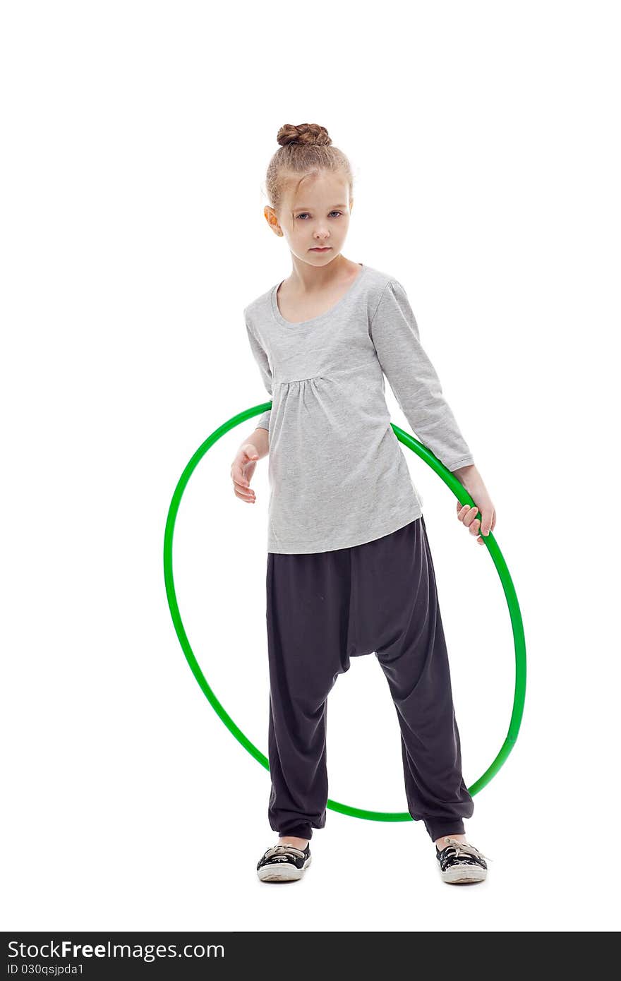 Sporty little girl with hula hoop posing on a white background. Sporty little girl with hula hoop posing on a white background