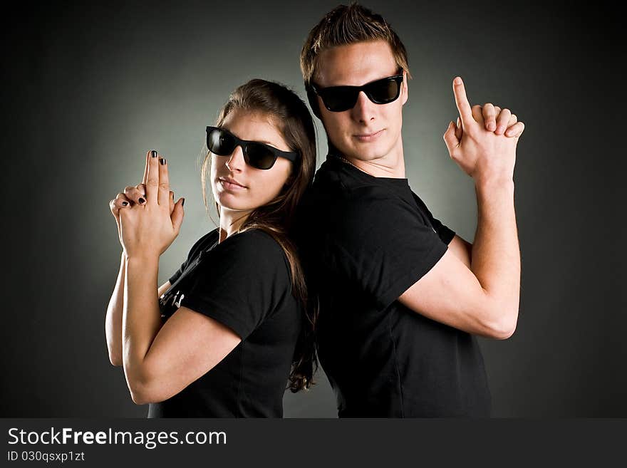 Wild couple with sunglasses and finger guns. Wild couple with sunglasses and finger guns