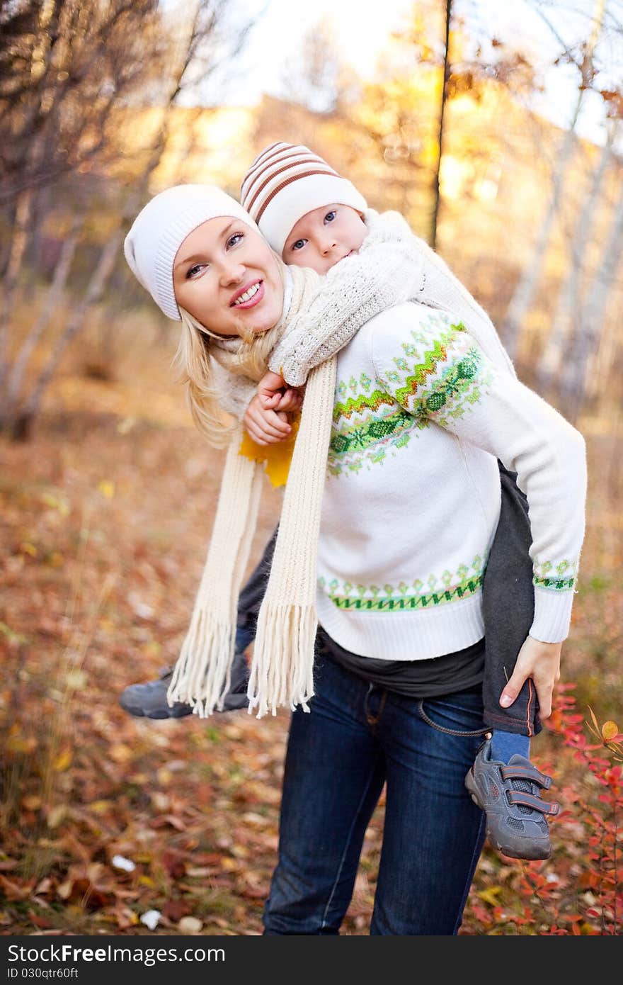 Happy young mother and her son spending time outdoor in the park. Happy young mother and her son spending time outdoor in the park