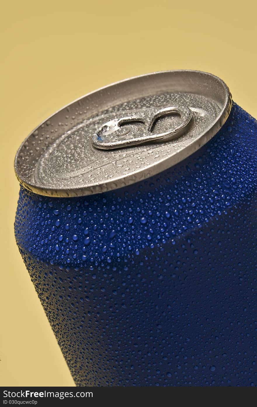 Blue soft can with some cold drops in a yellow background