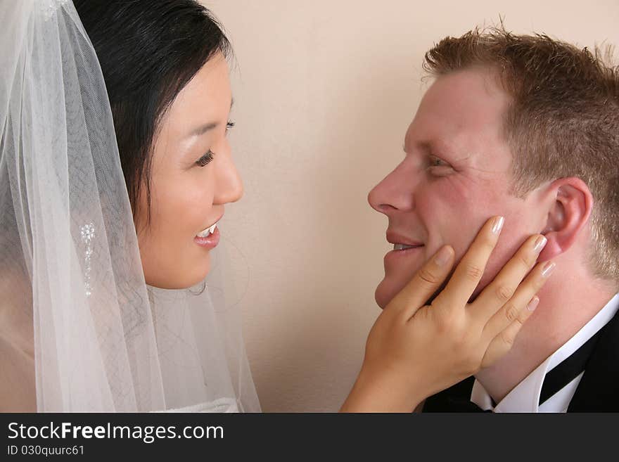 Bride and groom looking at one another. Bride and groom looking at one another