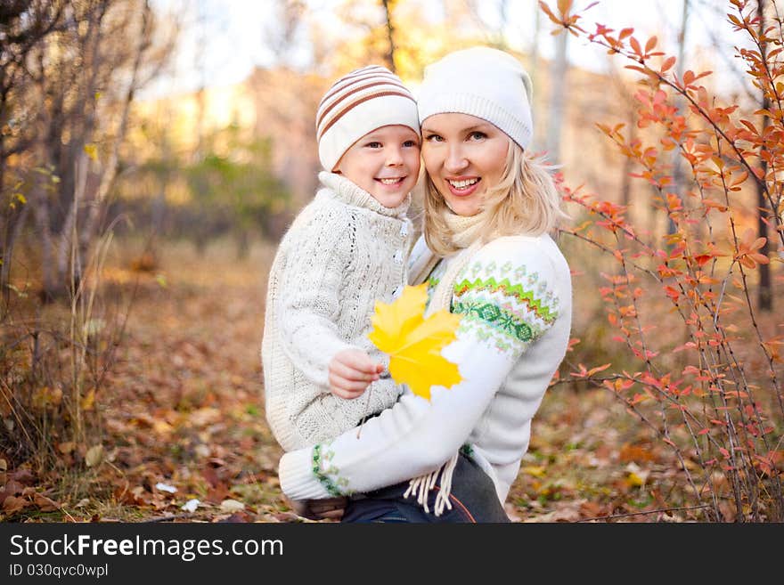 Happy young mother and her son spending time outdoor in the park. Happy young mother and her son spending time outdoor in the park