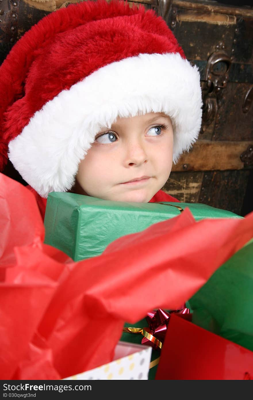 Little boy with big blue eyes wearing a christmas hat. Little boy with big blue eyes wearing a christmas hat