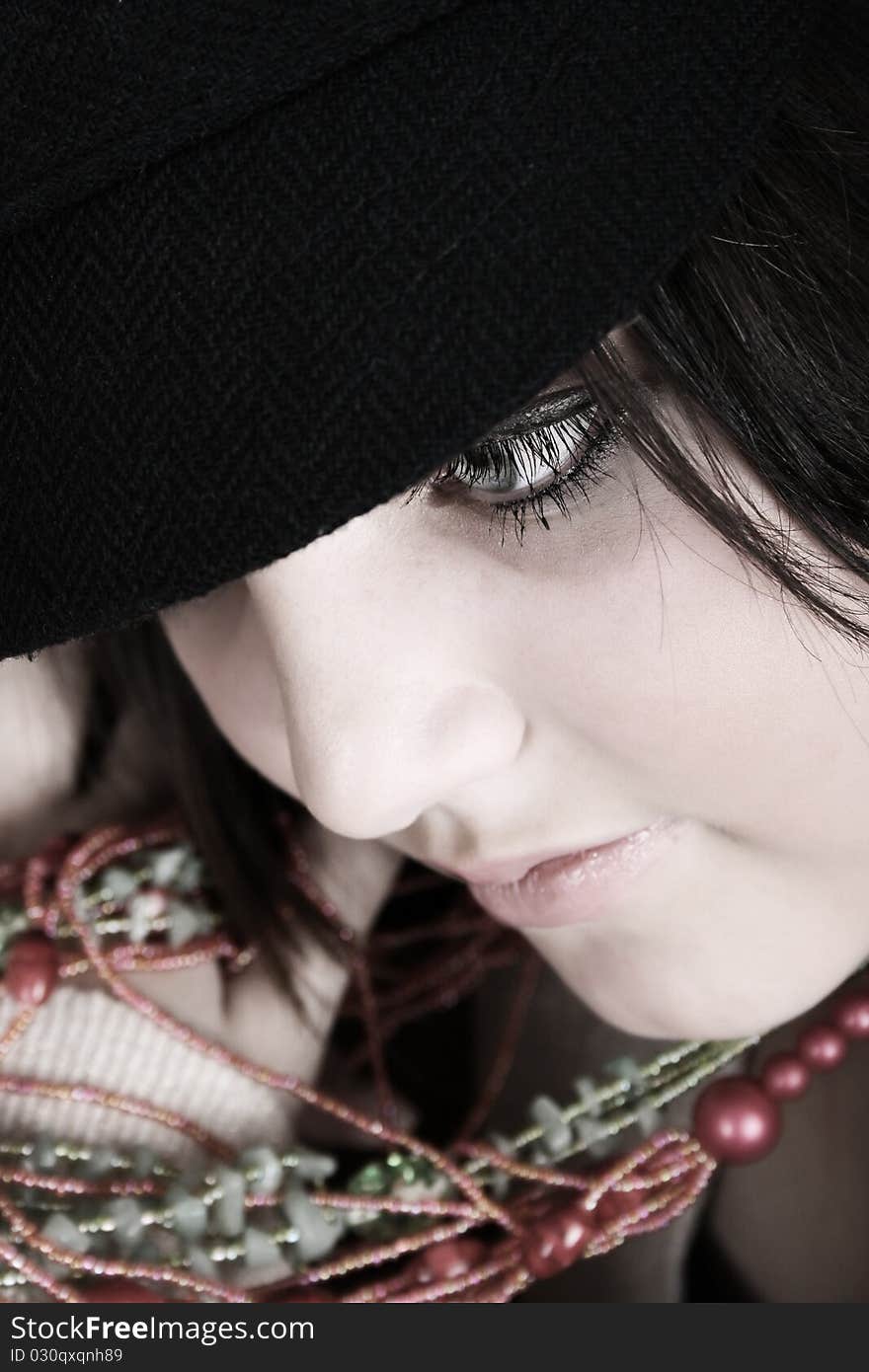 Close-up of a beautiful brunette teen wearing a hat. Close-up of a beautiful brunette teen wearing a hat