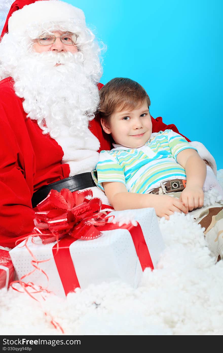 Christmas theme: Santa Claus and little boy with presents.