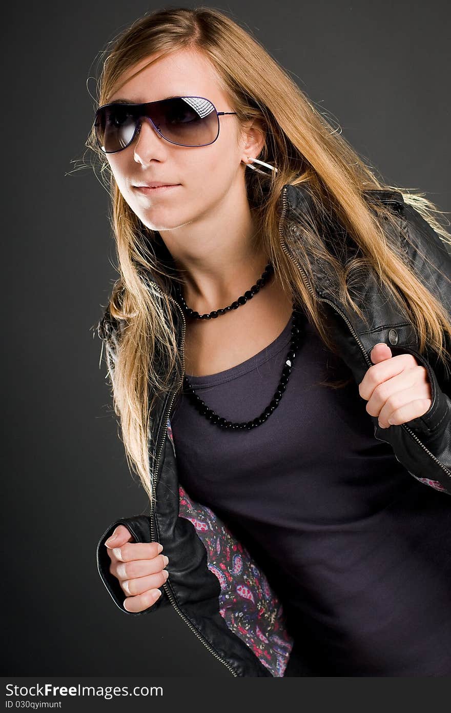 woman with sunglasses and open leather jacket. woman with sunglasses and open leather jacket