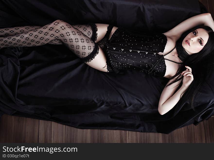 Beautiful woman in black lingerie on a sofa. Beautiful woman in black lingerie on a sofa.