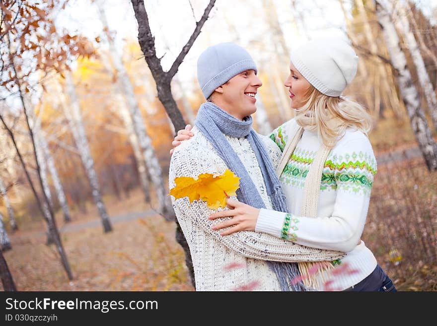 Happy young couple spending time outdoor in the park. Happy young couple spending time outdoor in the park