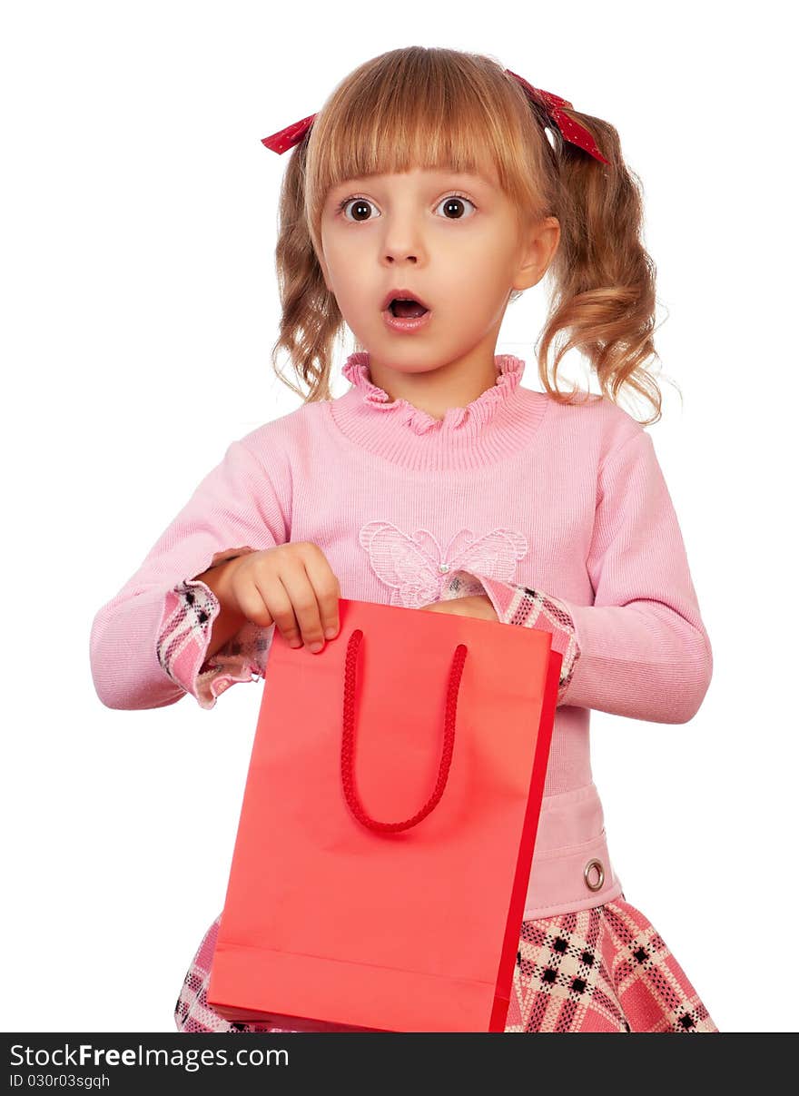 Surprised christmas girl holding shopping bag. Isolated on white background.