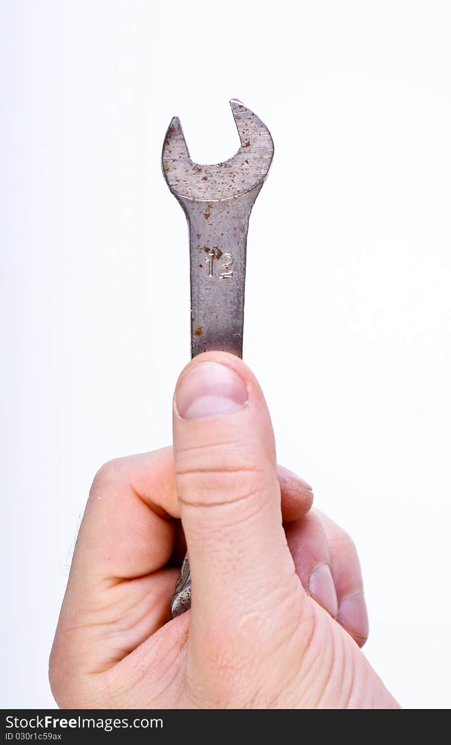 Mans hand holding a metallic tool. Mans hand holding a metallic tool