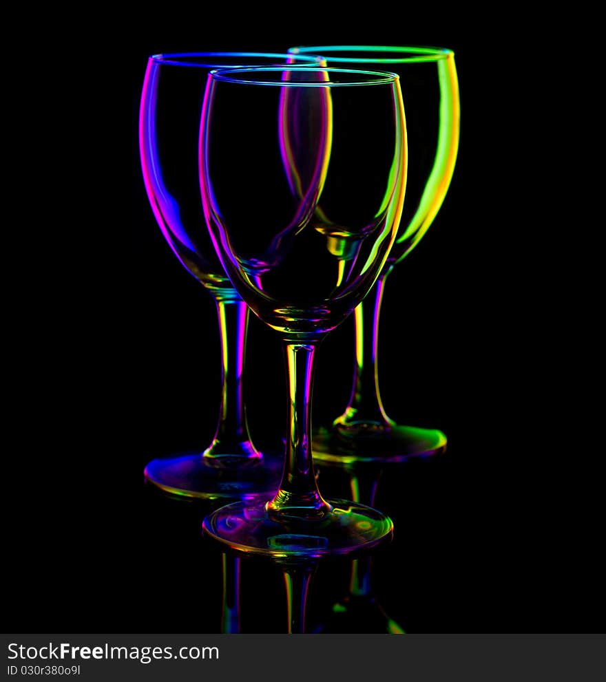 Three empty wine glasses on black