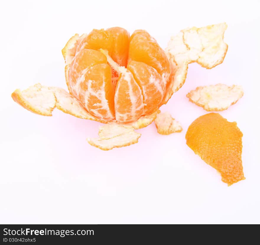 Mandarin orange, partially peeled, on white background