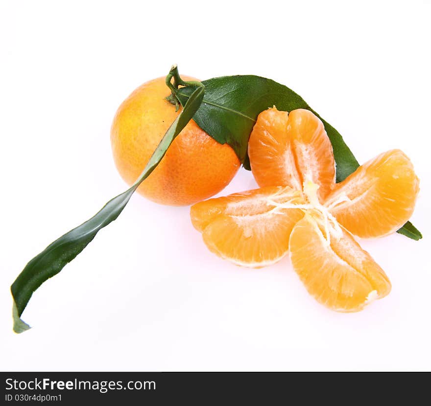 Mandarin with leaves and sections on white background. Mandarin with leaves and sections on white background