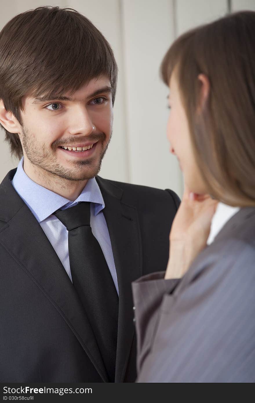 Business conversation - man and woman in suits talking together