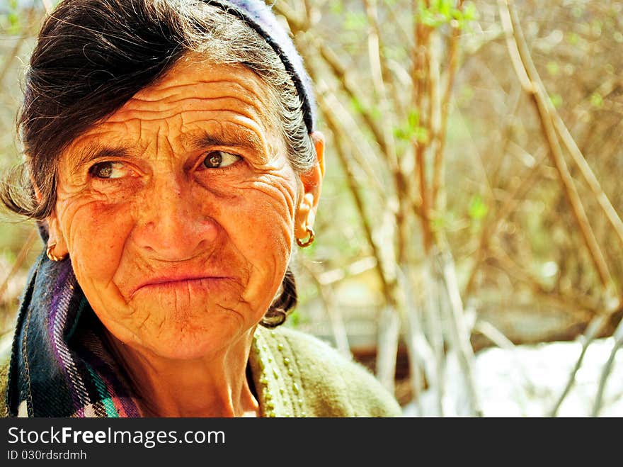 Old woman with dark bandana smiling. Old woman with dark bandana smiling