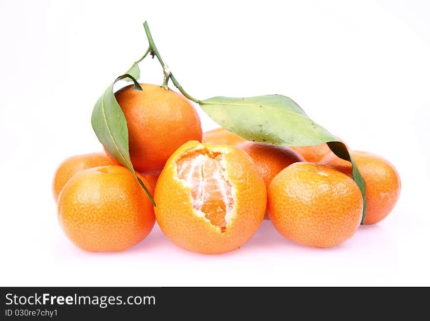 Mandarin oranges one partially peeled, on white background