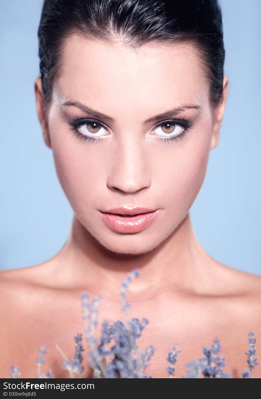 Portrait of beautiful woman, she holding bunch of lavender, isolated on blue. Portrait of beautiful woman, she holding bunch of lavender, isolated on blue