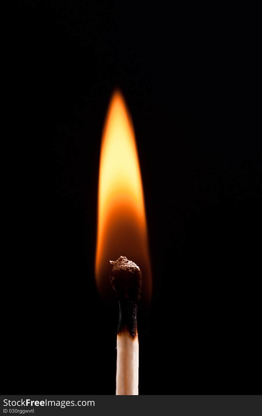 Burning match isolated on black background