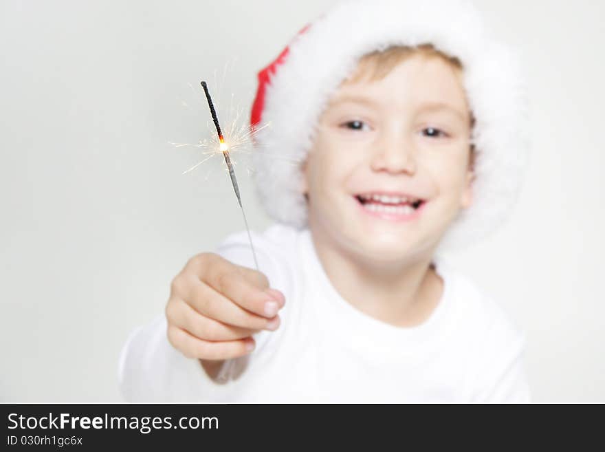 Santa boy with sparkler over white