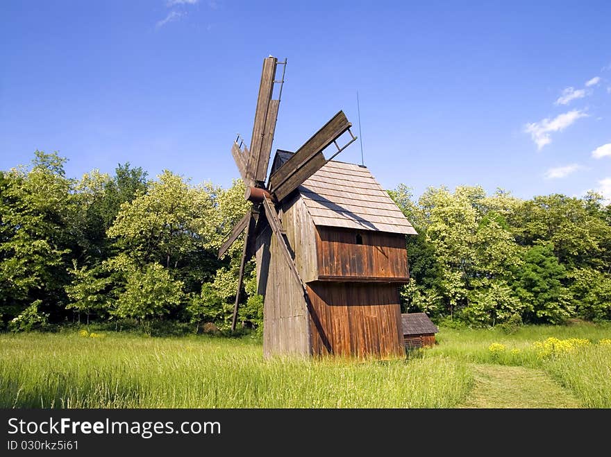 Windmill on green field