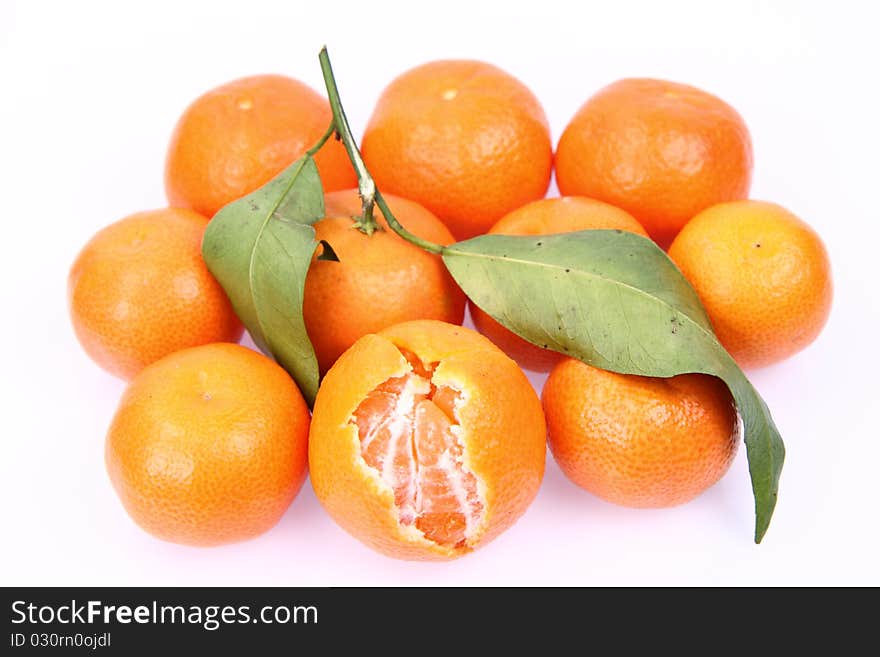 Mandarin oranges one partially peeled, on white background