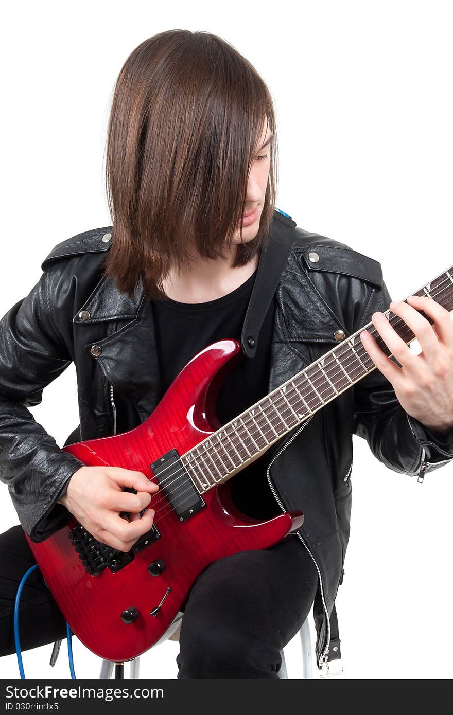 Rocker playing guitar isolated on white background