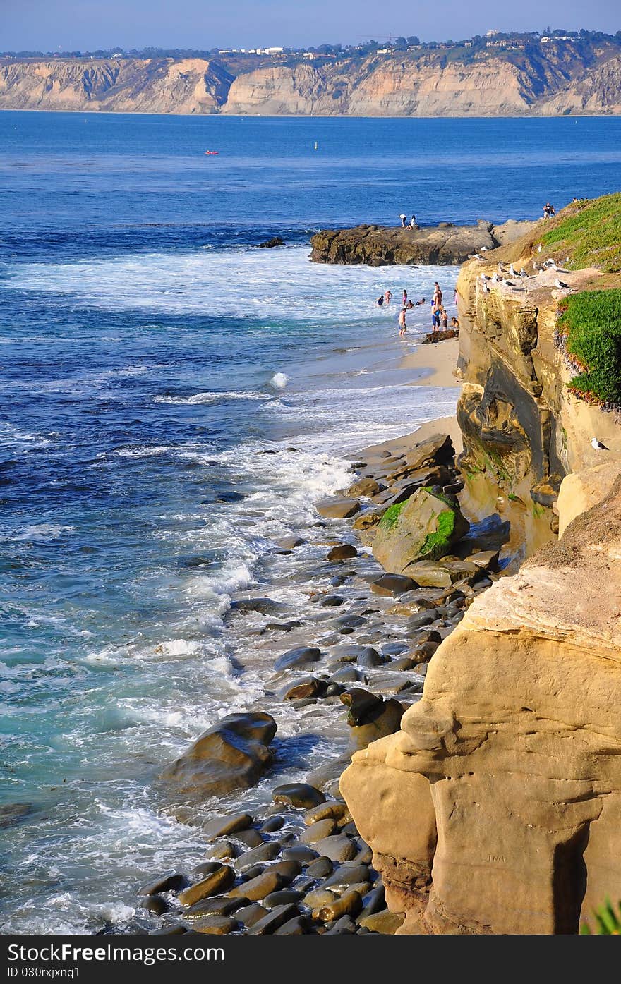 Rocky coastline with bluffs in the distance