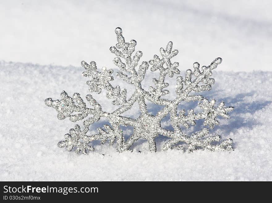 Beautiful silver snowflake in snow