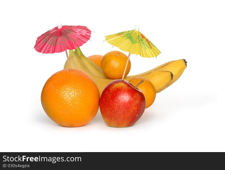 Orange and apple with small paper sunshades and other fruits on white background. Clipping path is included