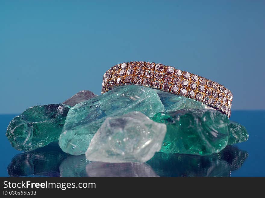 Fancy diamond braclet sitting on colored glass. Fancy diamond braclet sitting on colored glass