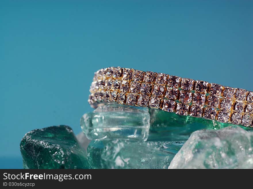 Fancy diamond braclet sitting on colored glass. Fancy diamond braclet sitting on colored glass