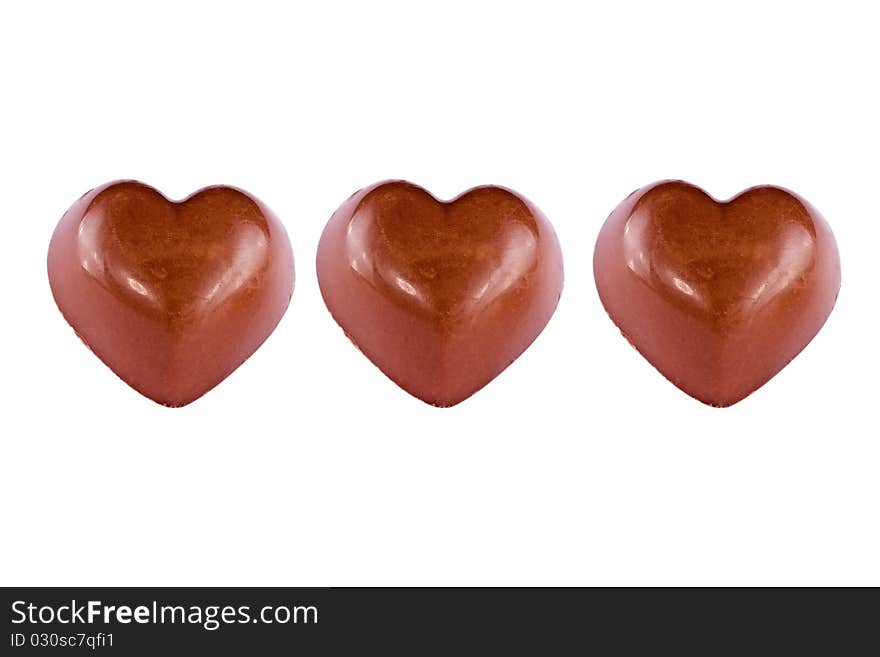 Three chocolate hearts, background, cake