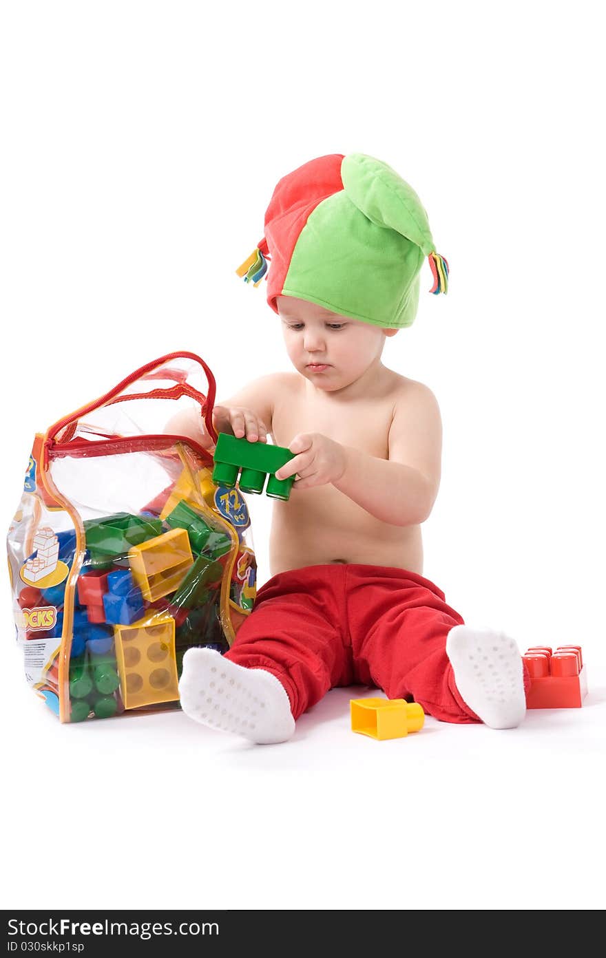 Little girl is sitting on the floor and playing with blocks. Little girl is sitting on the floor and playing with blocks