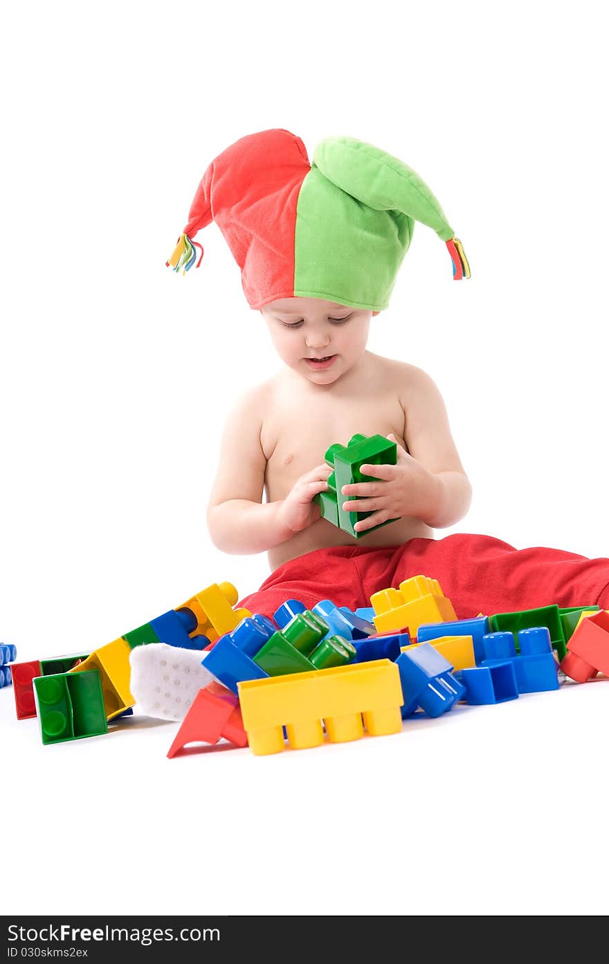 Little girl is sitting on the floor and playing with blocks. Little girl is sitting on the floor and playing with blocks