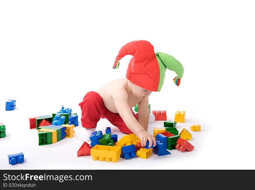 Little girl is sitting on the floor and playing with blocks. Little girl is sitting on the floor and playing with blocks