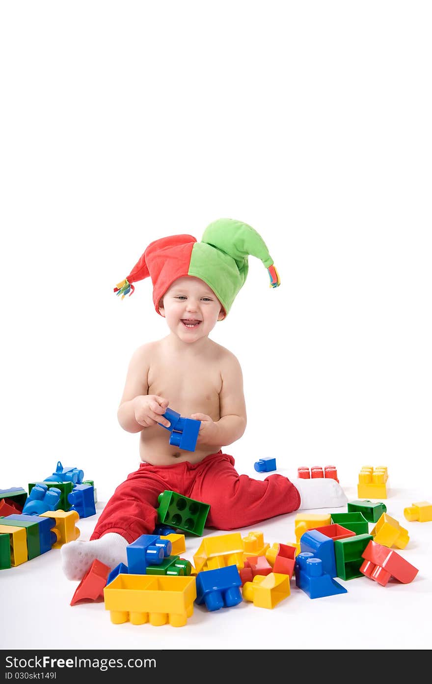 Little girl is sitting on the floor and playing with blocks. Little girl is sitting on the floor and playing with blocks